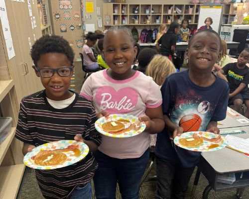  Three students posing with their flapjacks