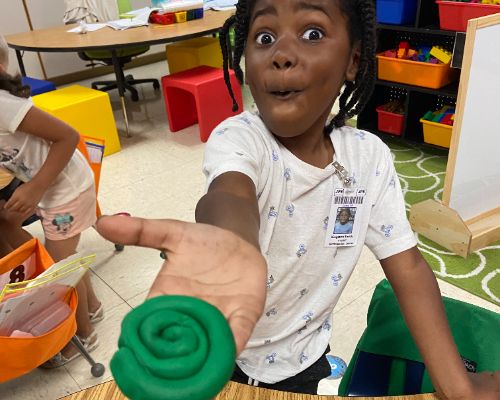 student with playdoh